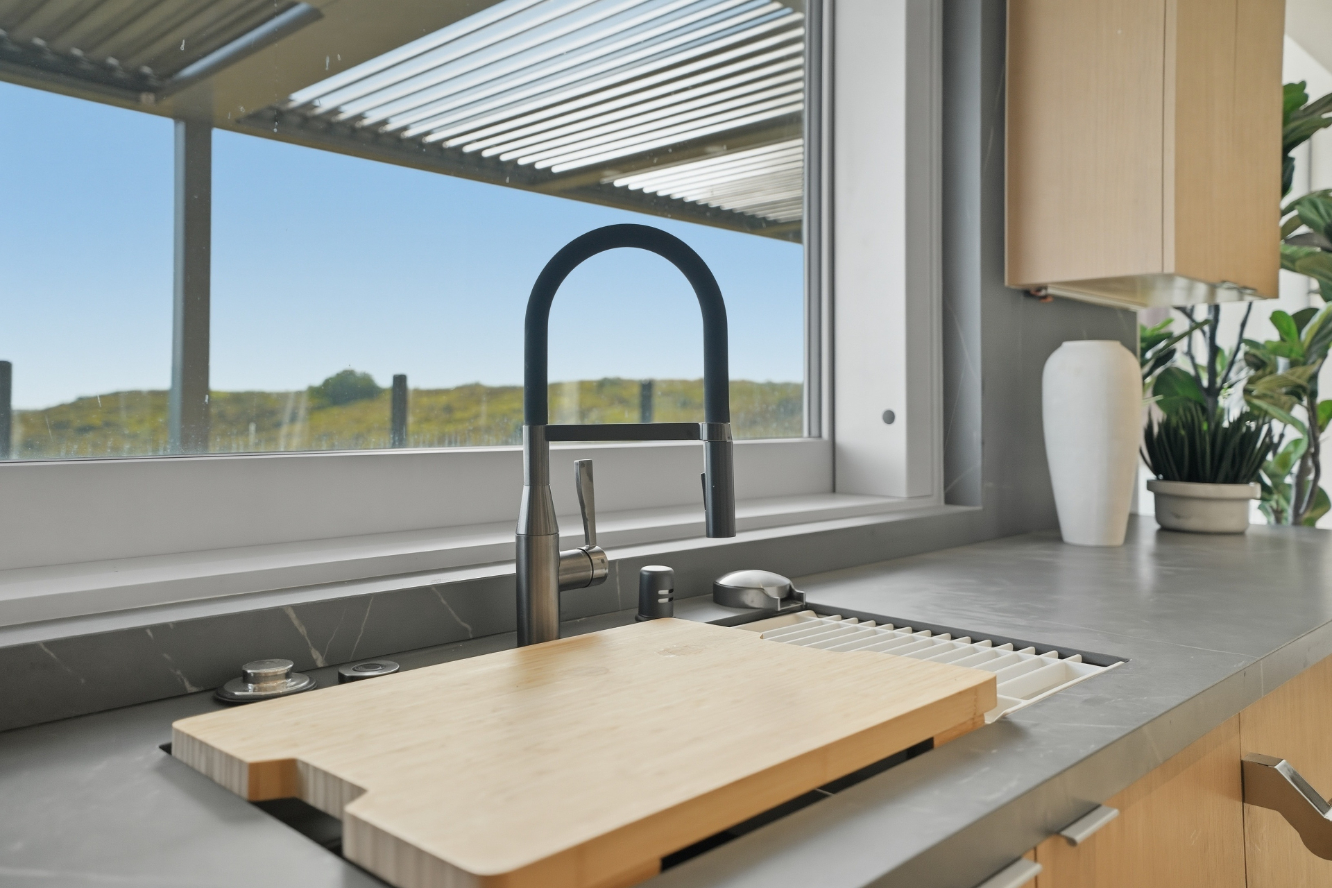 Interior detail photo of a modern kitchen faucet and countertop
