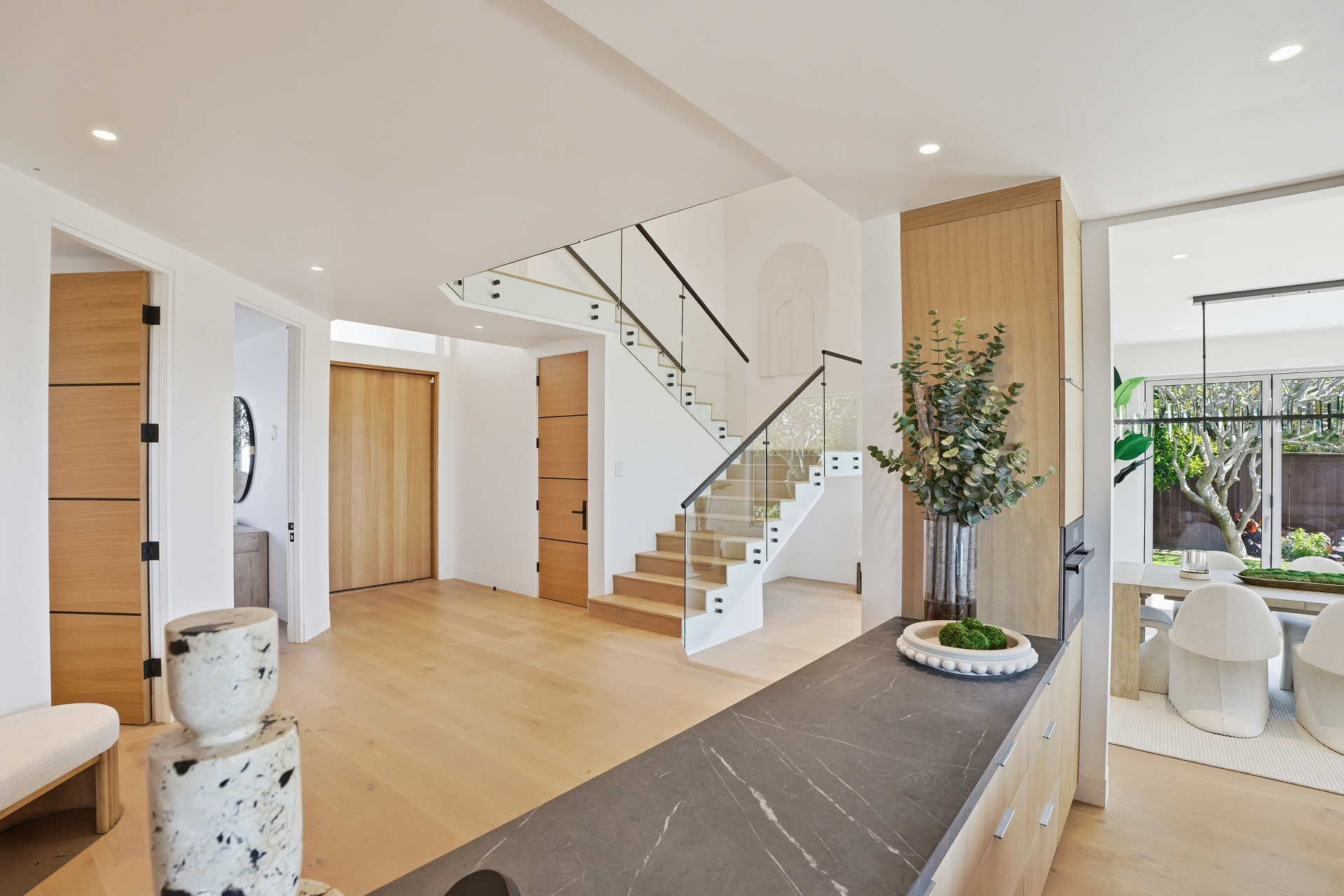 Modern interior entryway with staircase and warm wood finishes